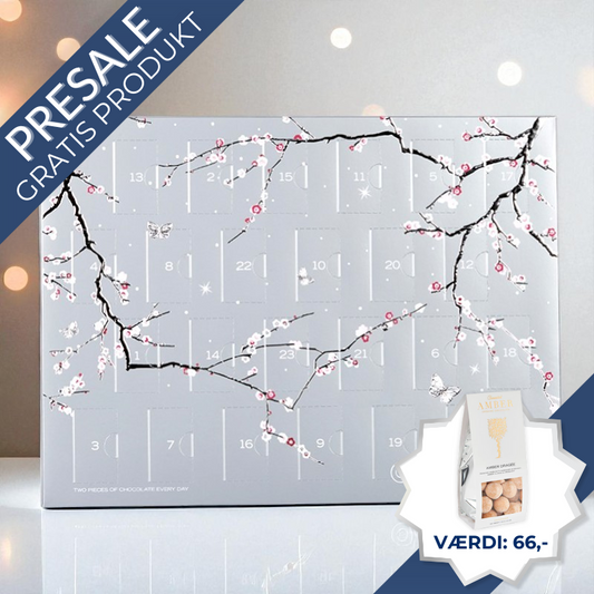 Elegant Summerbird julekalender med økologisk luksuschokolade – dansk håndværk i topklasse, sølvskinnende og sofistikeret design.	